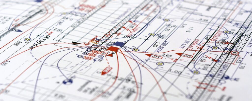 A detailed technical drawing or blueprint featuring various technical annotations, measurements, symbols, and diagrams. The drawing includes multiple colors such as red, blue, black, and yellow to indicate different elements and specifications related to the design and electrical safety.